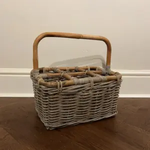 Natural wicker / rattan wine holder / bottle basket shown empty