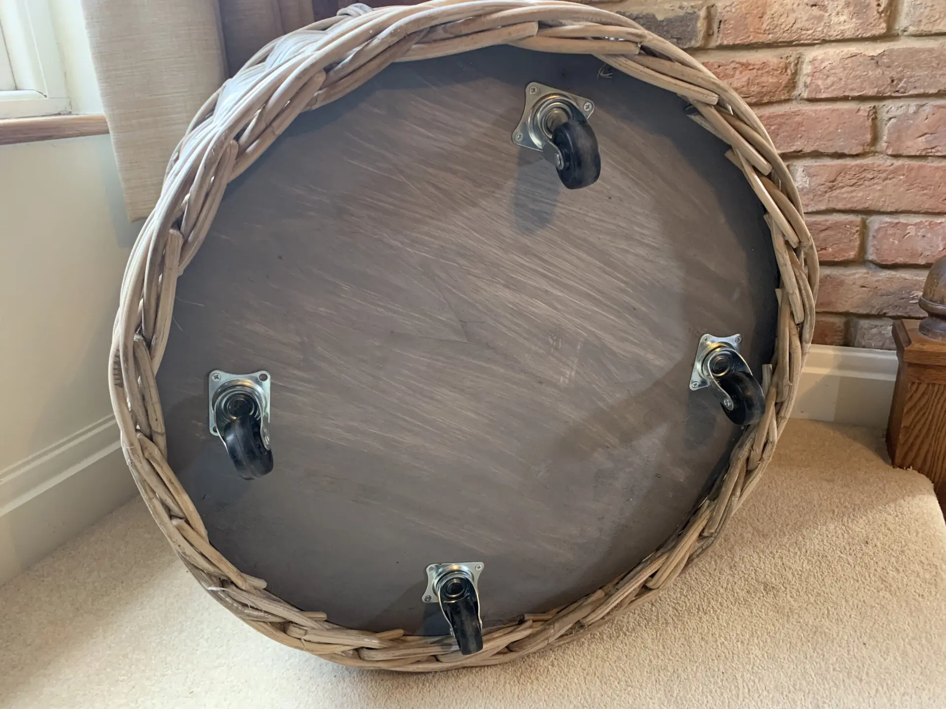 Round log basket with wheels made from natural rattan / wicker
